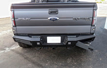 Load image into Gallery viewer, Addictive Desert Designs 10-14 Ford F-150 Raptor HoneyBadger Rear Bumper w/ Backup Sensor Cutouts